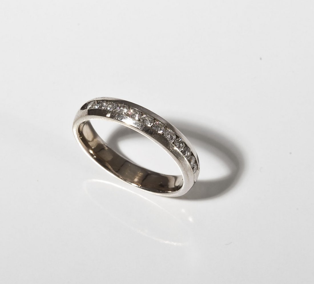.5 CTW Diamond Wedding Band: DESCRIPTION: Marked 14K white gold ring channel set with twelve approximately 5 point round diamonds. Approximately .5 ctw. MEASUREMENTS: Size 8-1/2. 2.9 dwt (4.6 gr). CONDITION: No defects noted.