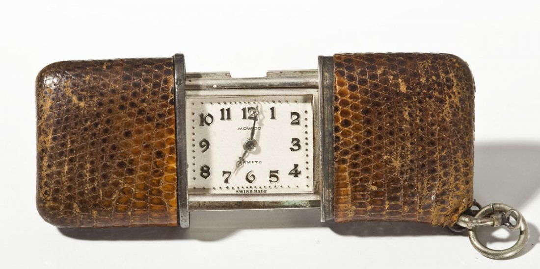 Movado Silver & Leather Cased Purse Watch: DESCRIPTION: Movado purse watch. White dial with silver numerals, Lancia hands, marked "Movado Ermeto Swiss Made". Case marked .935 Swiss Made Par Suise Patent" with brown leather sliding covers. Self