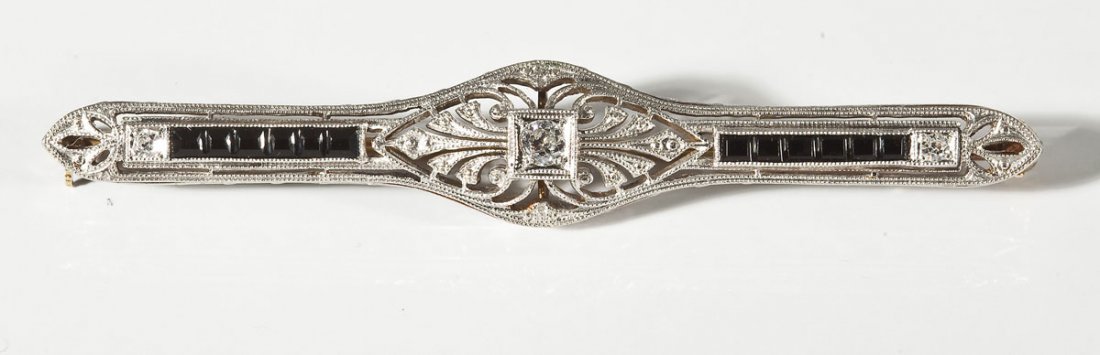 14K Diamond & Onyx Bar Pin: DESCRIPTION: Marked 14K filigree bar pin set with three diamonds (one approximately 10 point and two approximately 3 point) and two rows of square cut black onyx. MEASUREMENTS: 2-1/2" x 7/16". 3.9 dwt