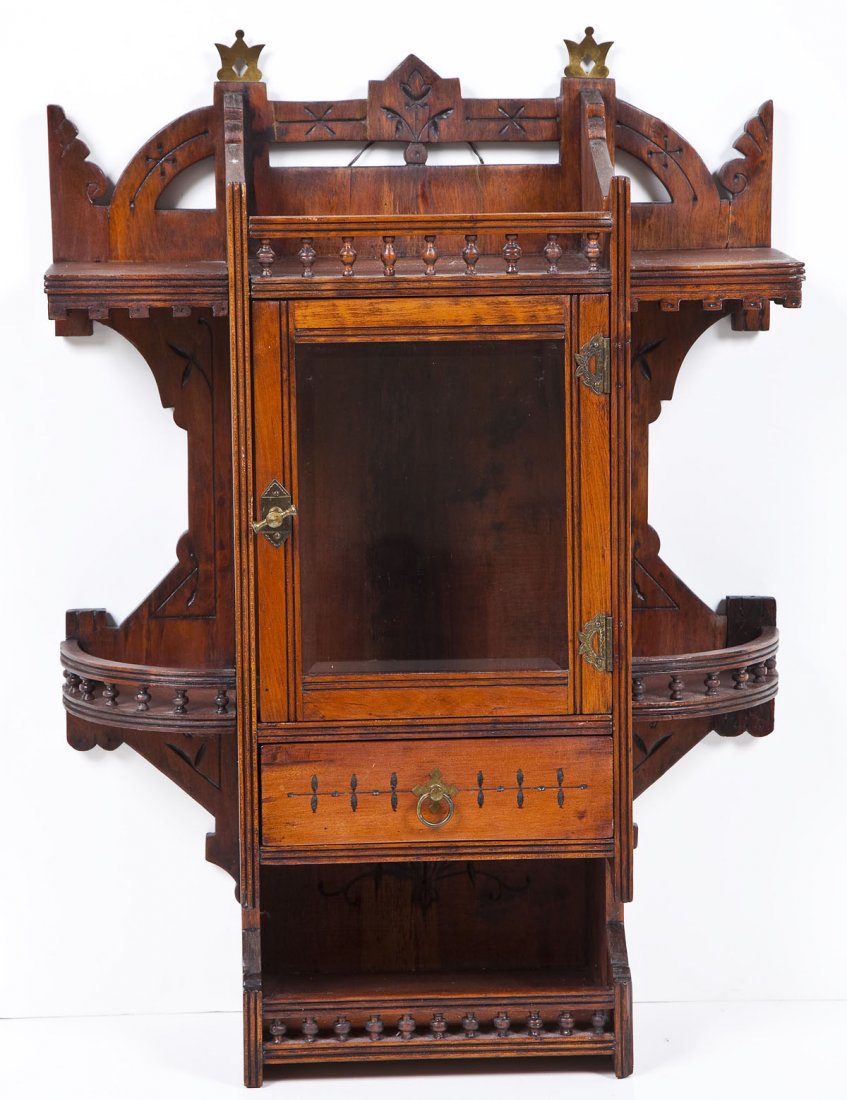 Victorian Eastlake Walnut Wall Hanging Cabinet: DESCRIPTION: Victorian Eastlake walnut wall hanging cabinet with glass display panel and drawer. Carved floral scrollwork ornamentation. MEASUREMENTS: 39" tall x 7-1/2" deep x 21" wide. CONDITION: Min