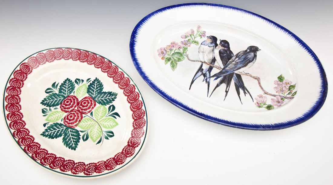 Feather Edge & Spongeware Platters: DESCRIPTION: Two unmarked serving platters. Includes: 1) 14-5/8" spongeware with red flower and green leaves. 2) 18-1/4" blue feather-edged with hand-painted swallows, signed "Kay Robok. 1960". MEASUR