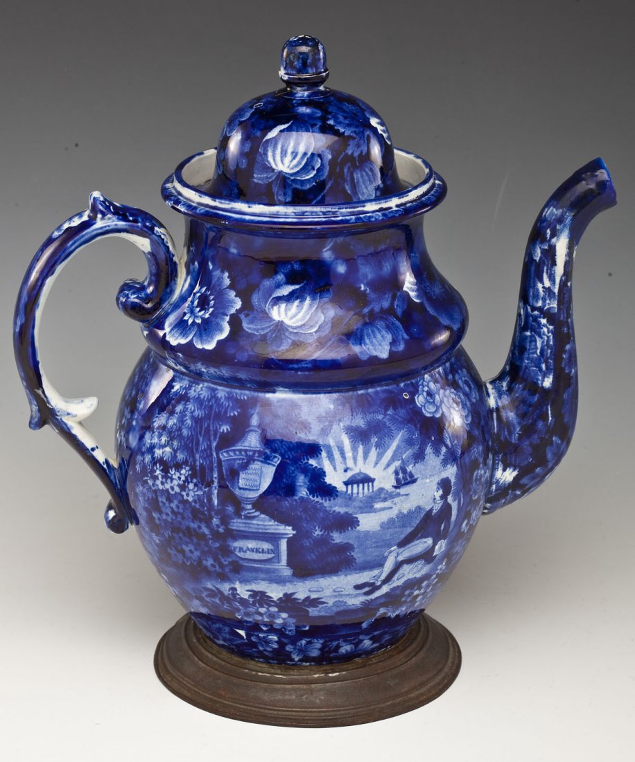 Historic Flow Blue Lafayette Franklin Tomb Teapot: DESCRIPTION: Historic flow blue teapot depicting Lafayette at Franklin's tomb. With "make-do" replacement base of pewter. MEASUREMENTS: 10-3/4" high with lid. CONDITION: Repair to finial on lid. 2-1/2