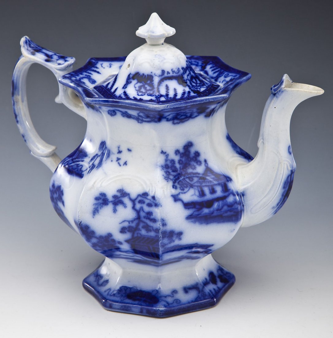 Flow Blue Hong Kong Teapot: DESCRIPTION: Flow blue teapot in the Hong Kong pattern by Charles Meigh. Unmarked. Circa 1845. MEASUREMENTS: 7-3/4" tall with lid. CONDITION: Chip to handle of lid.