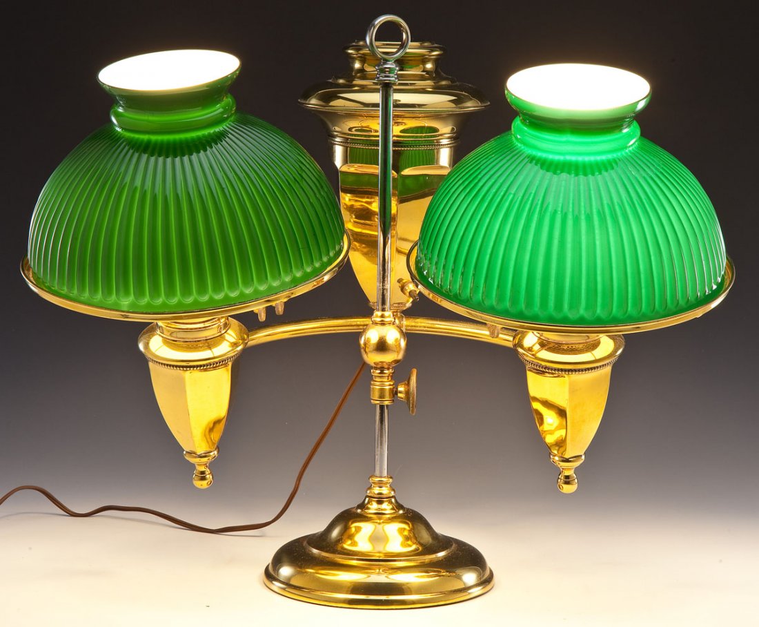 Duplex EM Double Student Lamp: DESCRIPTION: Duplex EM double student lamp. Brass body with two reproduction green glass shades. Adjustable height. Marked on light knobs "E Duplex M". MEASUREMENTS: 25" high, fully extended x 22" at