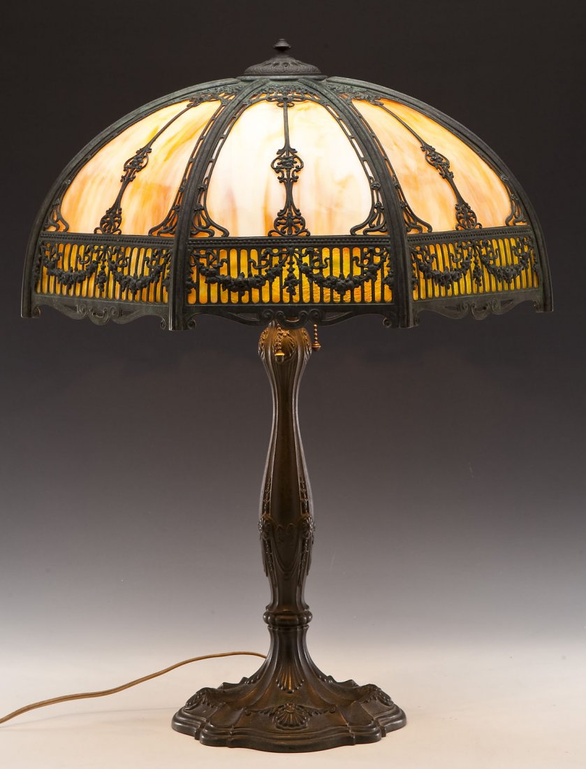 Bronze Patinated & Slag Glass Table Lamp: DESCRIPTION: Slag glass lamp. Caramel slag glass octagonal shade. Bronze patinated base with shell and flower motif. Marked underneath base "537". MEASUREMENTS: Lamp 26" high. Shade 21-1/2" diameter. 