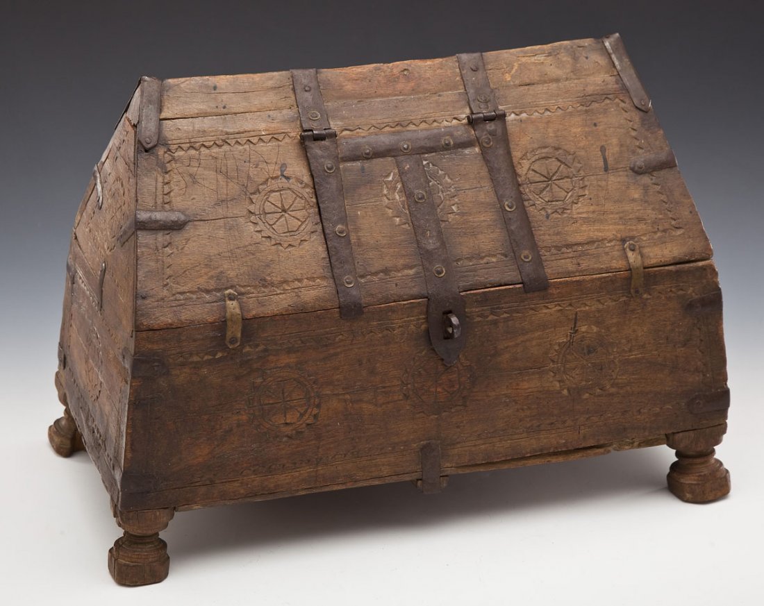 Northern Medieval Wooden Box: DESCRIPTION: Northern medieval wooden footed box with metal forged hardware and carved rosettes. Possibly Scandinavian or Anglo Saxon. Rectangular frame with gabled top. 4-3/4" x 5-3/4" hatch door on 