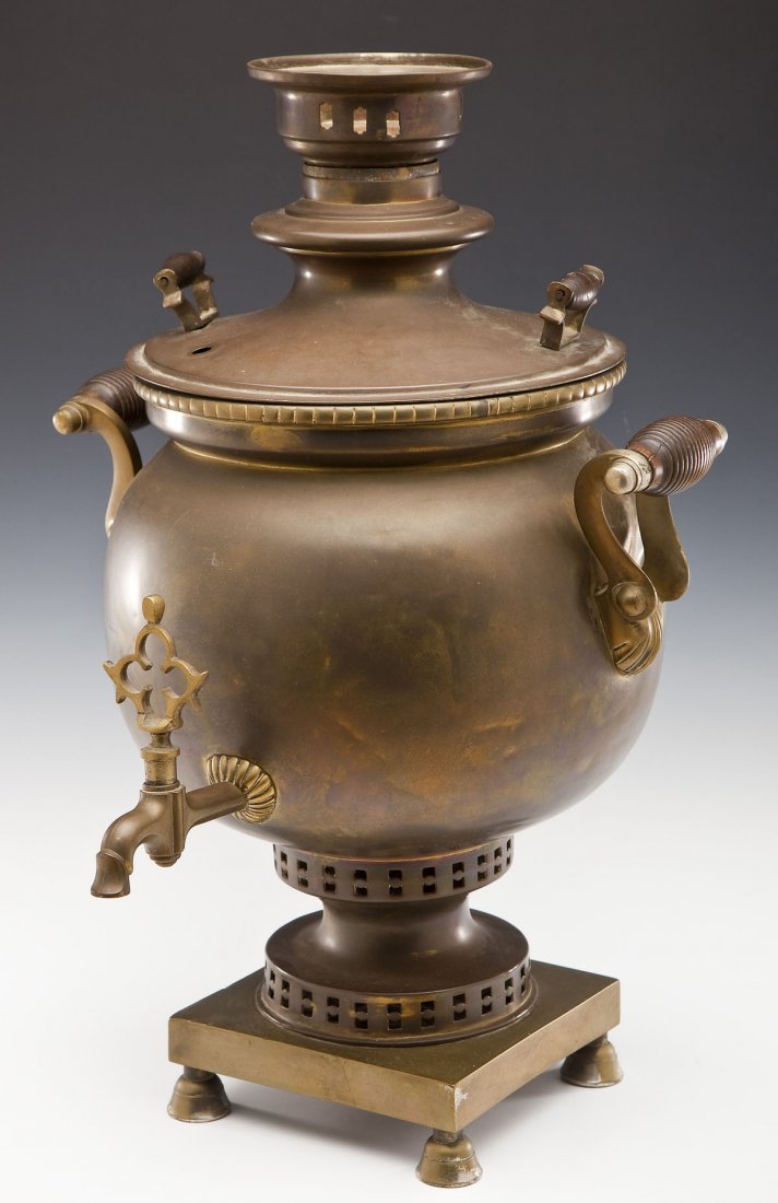 Large 19th C Russian Brass Pot-Bellied Samovar: DESCRIPTION: Large 19th century Russian brass pot-bellied samovar with wooden grips to handles. Chimney attached inside. Includes lid and teapot base. Wood or coal fire heated. Shallow mark on top of 
