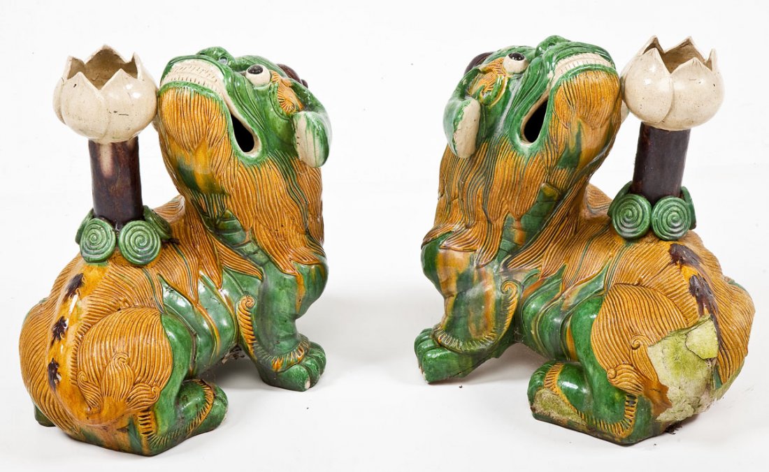 Pr of Chinese Foo Dogs with Lotus on Back: DESCRIPTION: Pair of Chinese Foo dogs with lotus on back in yellow and green glaze. MEASUREMENTS: Each 18" tall. CONDITION: One with light surface wear. Other with losses to top of head, rear left leg