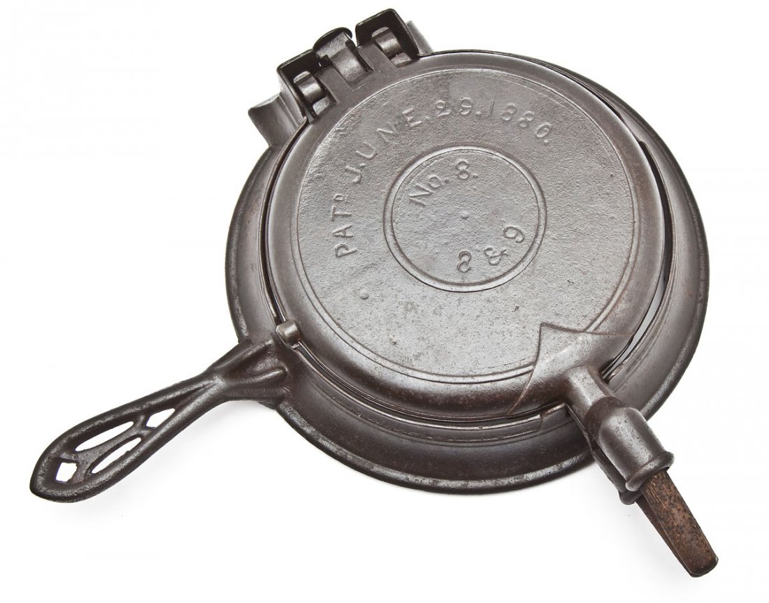 Griswold No. 8 &9 American Waffle Iron: DESCRIPTION: Griswold No. 8 &9 American Waffle Iron, Button Hinge, Low Base. Catalog/Part No: None. MEASUREMENTS: 14" long. CONDITION: Minor wear as expected with age.