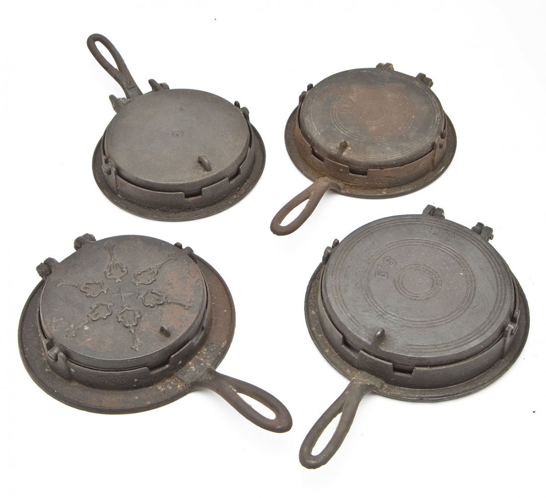 4 Waffle Irons on Bases: DESCRIPTION: Four Waffle irons on bases. Includes: 1) 13-3/4" long with ornate lid. Apparent wear throughout including rusting, oxidation, and residue. 2) 13-1/2" long with "7" stamped on top and hand