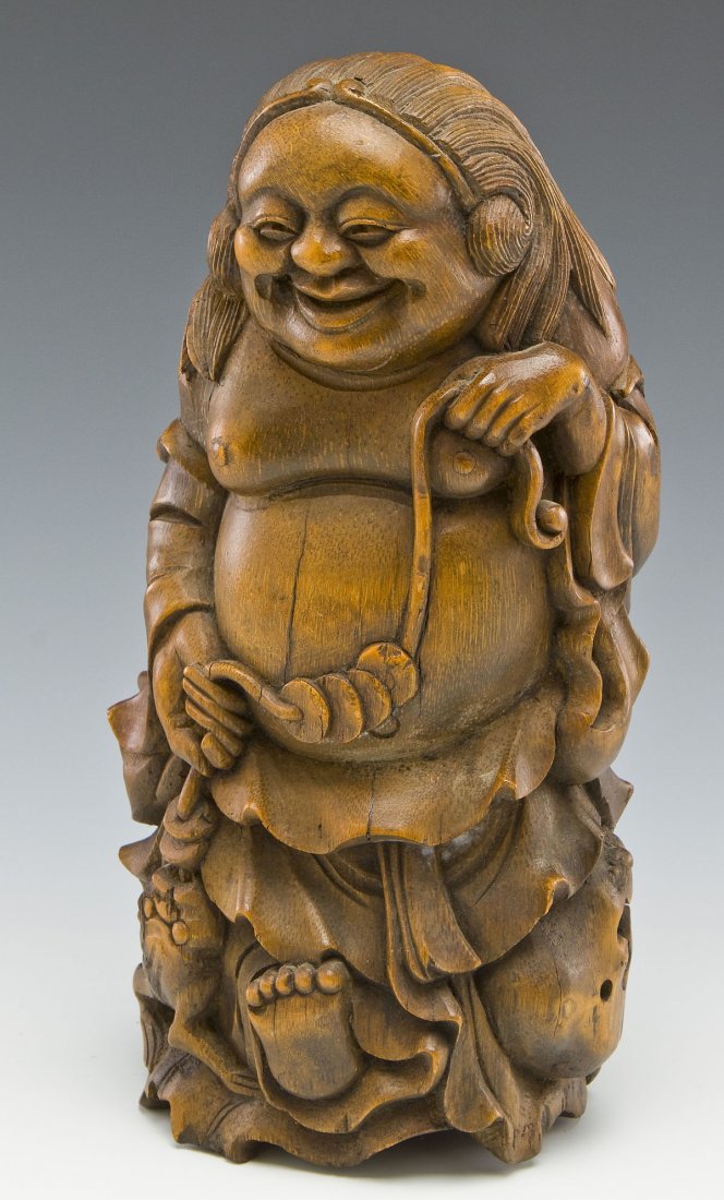 Chinese Carving Liu Hai Carrying the Golden Toad: DESCRIPTION: Chinese carved wood figure of Liu Hai walking and carrying the three-legged toad on the end of a rope with gold coins. Liu Hai is loosely clothed. MEASUREMENTS: 11-3/4" tall. CONDITION: M