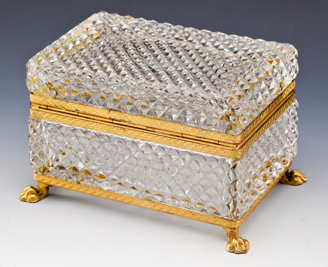 Diamond Pattern Cut Glass Dresser Box: DESCRIPTION: Diamond pattern cut glass dresser box with ormolu trim, lion's feet and lion head detail. MEASUREMENTS: 6-1/2" long x 4-1/2" deep x 4" tall. CONDITION: Minor wear to brass trim. Bend in b