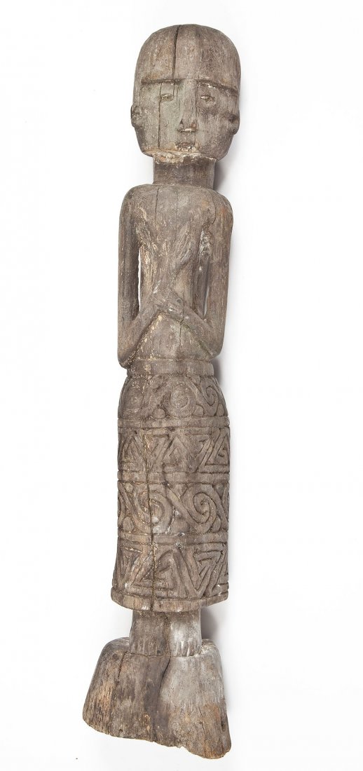 Dayak Hampatong, Borneo / Indonesia: DESCRIPTION: Dayak Hampatong ancestor figure. Carved iron wood female figure wearing floral carved decorated skirt, holding one hand across chest with the other hand clasping wrist. MEASUREMENTS: Appr