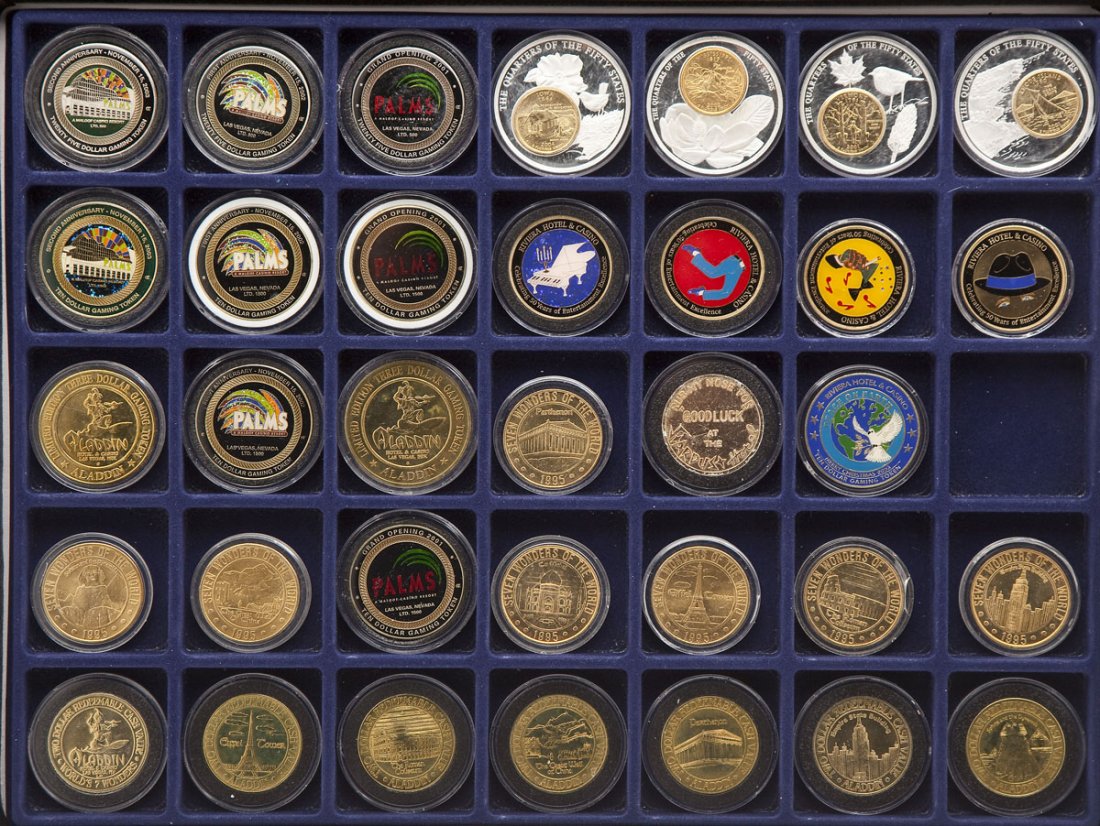 30 Casino Gambling Tokens: DESCRIPTION: Thirty casino gambling tokens from varying casinos including the Aladdin Casino & Hotel, the Palms, and the Riviera. Ranging from $10-$25 casino value. Together with four encased state qu
