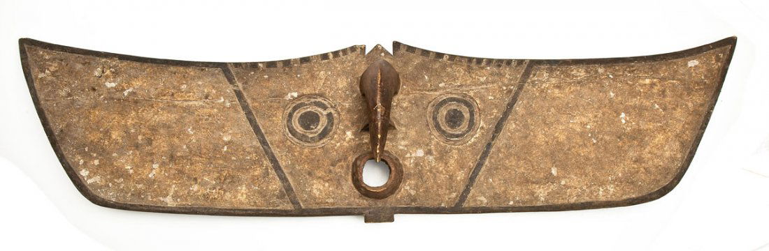 Carved Bwa Hawk Mask Burkina Faso: DESCRIPTION: Carved Bwa hawk plank mask, Burkina Faso. Long wing-shaped mask with curved beak and protruding mouth. Holes for fasteners. PROVENANCE: From the Saul and Florence Putterman Collection, Sa