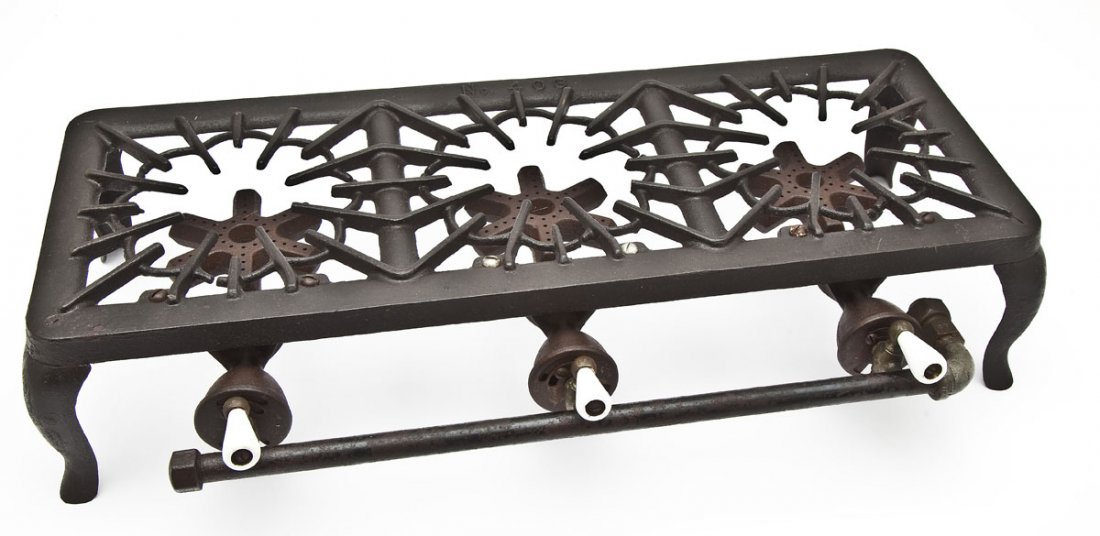 Griswold No. 403 Gas Hot Plate: DESCRIPTION: Griswold Gas Hot Plate, No. 403, Triple Burner, Low Stand. Catalog/Part No: 1160, 1170, 1701. MEASUREMENTS: 26" long. CONDITION: Minor wear and patina as expected with age.