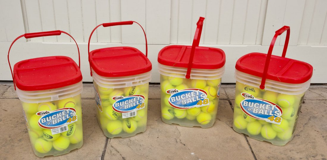 4 Buckets of Gamma Tennis Balls: DESCRIPTION: Four buckets of Gamma tennis balls. Approximately 48 balls in each. MEASUREMENTS: Each bucket 12" x 9-1/2" x 12-1/2". CONDITION: Light use.