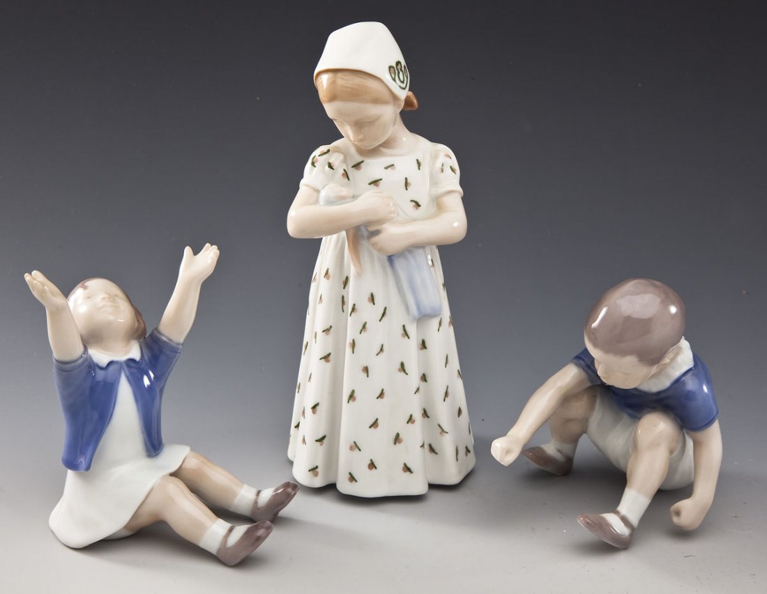 3 Bing & Grondahl Figurines: DESCRIPTION: Three Bing & Grondahl figurines. Includes: 1) #1636 figure of a boy in a blue shirt. 3-3/4" tall. 2) #2324 figure of girl with open arms and a blue shirt 3-3/4" tall. 3) #1721 figure of a