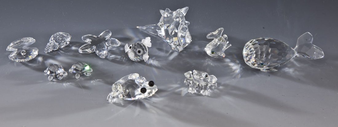 10 Swarovski Water Related Figurines: DESCRIPTION: Ten Swarovski water related figurines. Includes: 1) South Seashell 7624072000160798 in original box. 3". 2) Seashell 7624NR000002 in original box. 1-1/4". 3) Clam with pearl NR0000305 in 