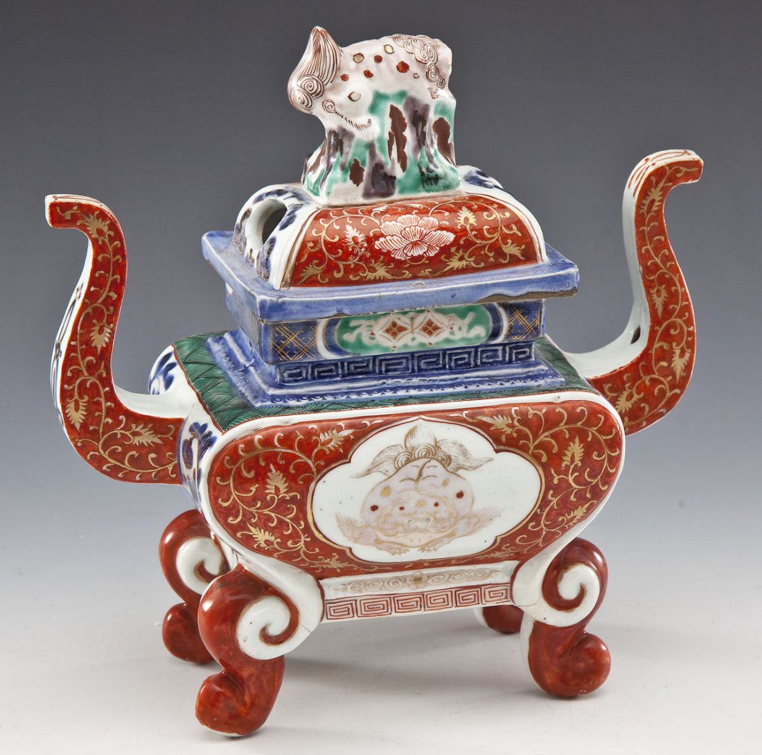 Chinese Porcelain Censer with Foo Dog Finial: DESCRIPTION: Chinese porcelain censer with foo dog finial. Square base with four feet and two curve handles. Two cut away holes on lid for release of incense. Hand painted, gold motifs, blue underglaz