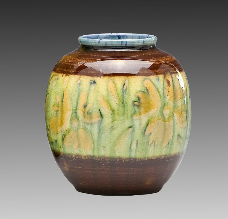 Rookwood Vase 6183F by Elizabeth Barrett: DESCRIPTION: 1944 Rookwood Pottery Studios hi-glaze vase with green register of flowers, blue lip and brown base. Stamped on underside with Rookwood Pottery symbols "XLIV", E. Barrett cipher, and styl