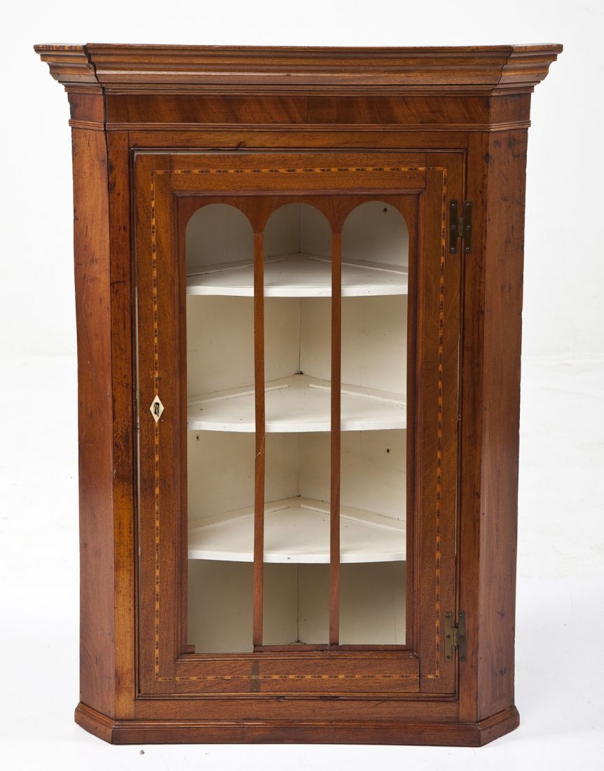 Federal Hanging Corner Cupboard: DESCRIPTION: A late 18th century Federal hanging corner cupboard consisting of four shelves behind a three arched glazed door with inset striped inlays and a bone escutcheon. The case with an elaborat