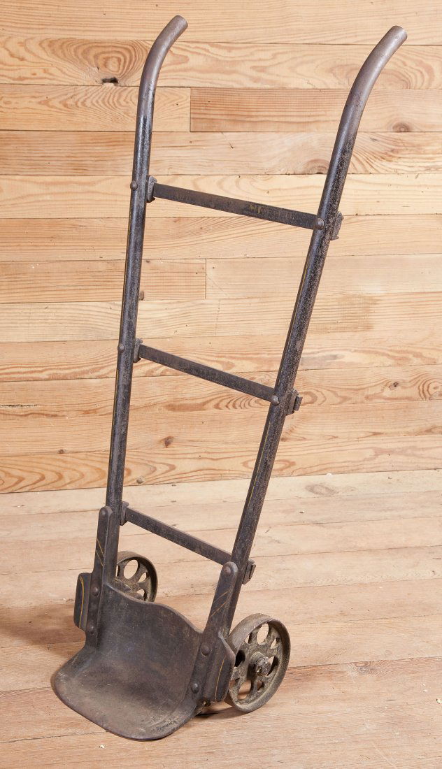 Mill Bag Cart: DESCRIPTION: Mill bag cart of cast iron and pressed steel. Traces of yellow pinstriping and stenciling. MEASUREMENTS: Handle 19" wide. 44" overall.