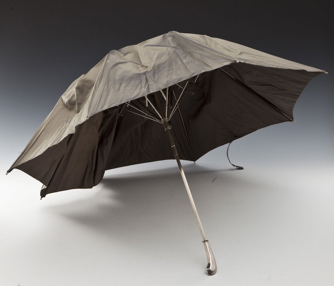 Verdura Sterling Handled Umbrella: DESCRIPTION: Sterling handled umbrella by Verdura. Gray canopy. Handle marked "Verdura 925 Sterling." Cap marked "Sterling." Canopy with tag reading "100% Polyester / Made in Italy." MEASUREMENTS: Han