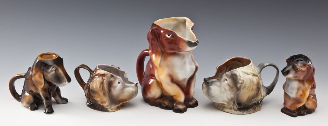 5 Royal Bayreuth Dog Vessels incl. Dachshund: DESCRIPTION: Five Royal Bayreuth dog vessels. Includes: 1) St. Bernard milk. 4" tall. 2) St. Bernard creamer with blue stamp on underside. 3-1/2" tall. 3) Dachshund hat pin holder with blue stamp on u