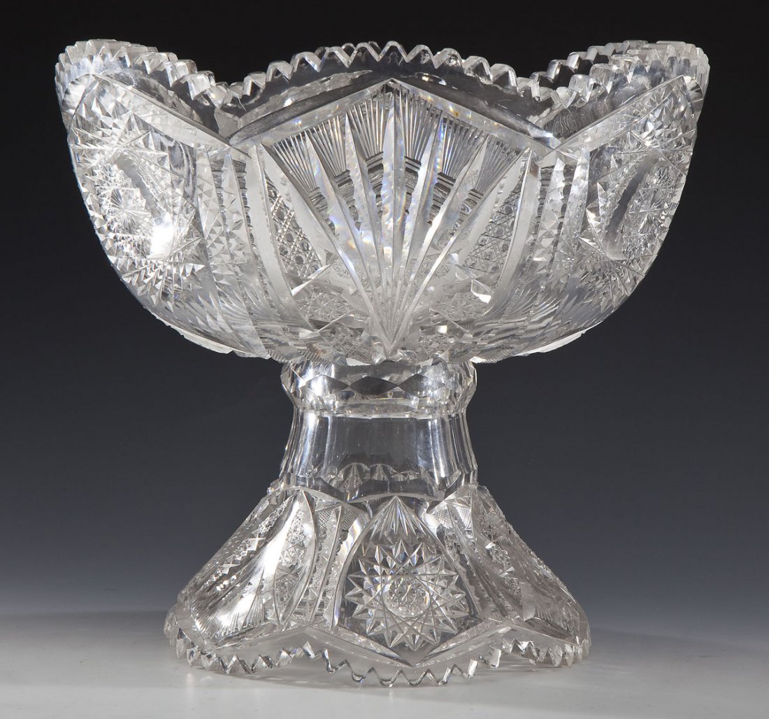 Fry Keystone Footed Cut Glass Punch Bowl: DESCRIPTION: Two part footed cut glass punch bowl in the Keystone pattern by Fry Glass Company. Fans and star patterns to surface with crenellated and scalloped lip and foot. MEASUREMENTS: 9-1/2" tall