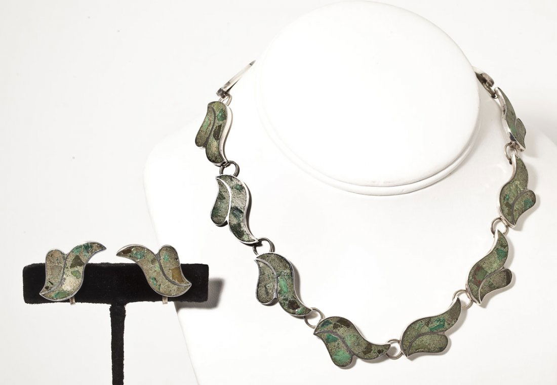 Silver Necklace & Earrings: DESCRIPTION: Necklace marked "Hecho in Mexico Sterling Mexico" comprised of 12 stylized wave links inlaid with green mosaic. Matching screw-back earrings marked sterling. MEASUREMENTS: Necklace 14". E