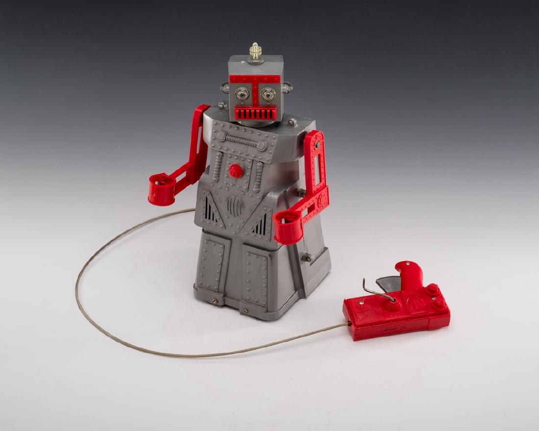 Ideal 1950s Robert the Robot in Original Box: DESCRIPTION: Ideal Robert the Robot. Comes with original box and remote control. Circa the 1950's. MEASUREMENTS: Robot 14-1/2" tall. CONDITION: Working. Rust to base. Separation of seam upon right sid