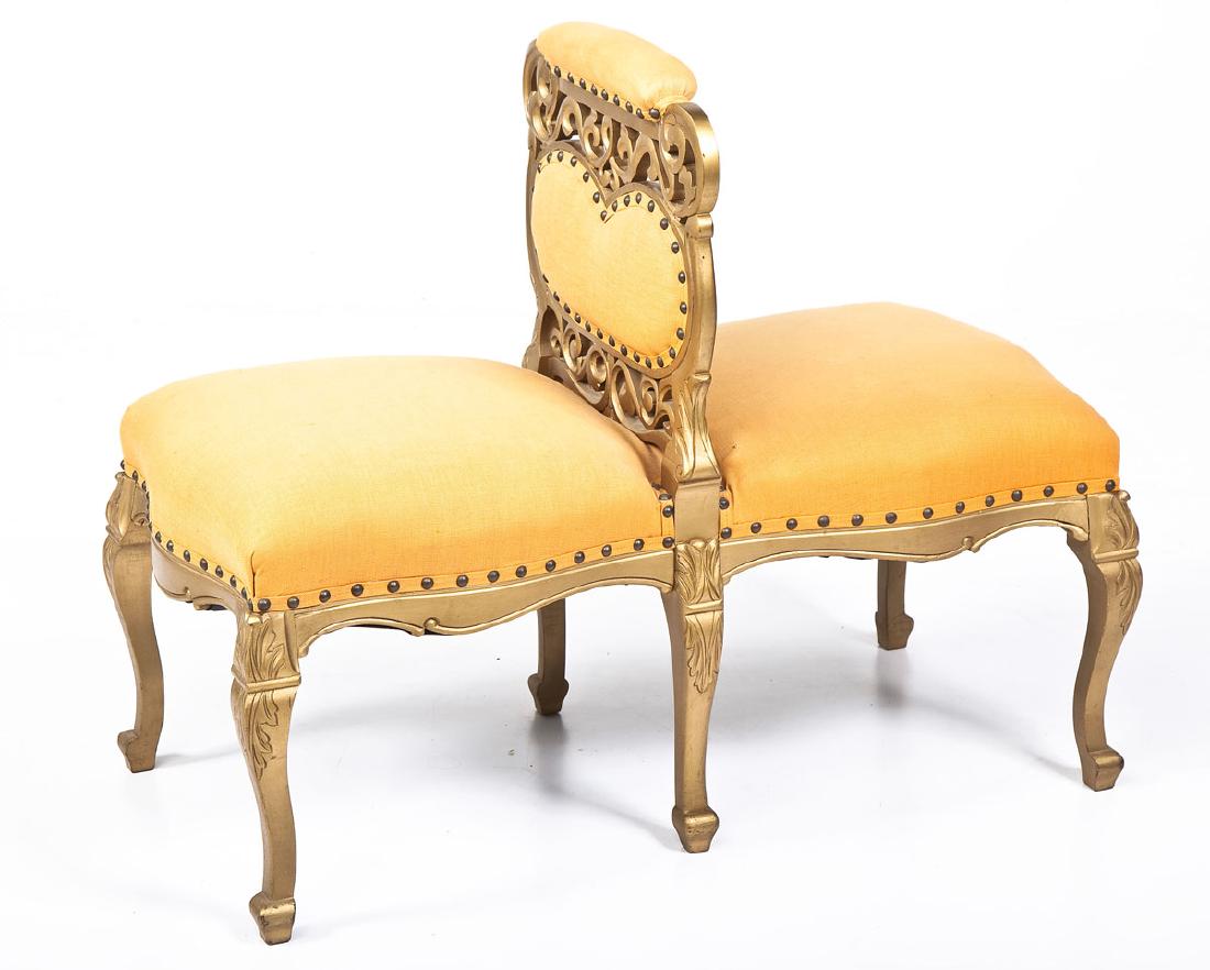 French Revival Courting Bench: DESCRIPTION: A French Revival courting bench consisting of a back to back overstuffed frame divided by a pierced gilded upright, all resting on cabriole legs. MEASUREMENTS: 31” x 32-1/2” x 20”.
