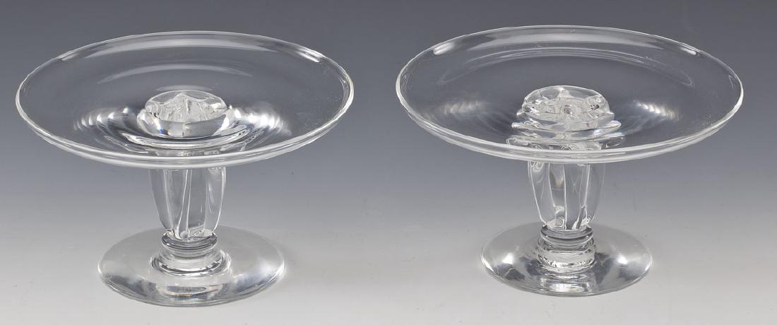 Pair of Steuben Dessert Trays: DESCRIPTION: Pair of Steuben dessert trays with scrolled pedestals. Signed to bottom. MEASUREMENTS: 3-3/4" tall x 6-1/2" diameter. CONDITION: Minor wear to feet as expected with use.