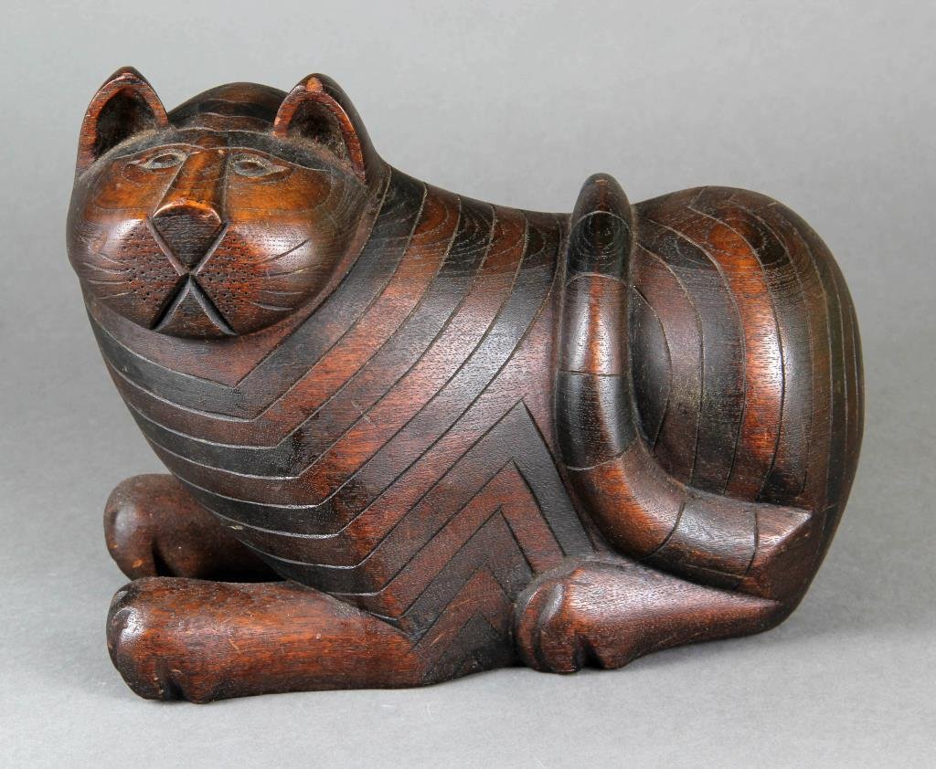 An American Folk Art Carved Cat: A nice folky three-dimensional carving of a plump cat, having a fine old surface, 10.5"W X 8.5"H X 5"D, circa 19th/early 20th century.