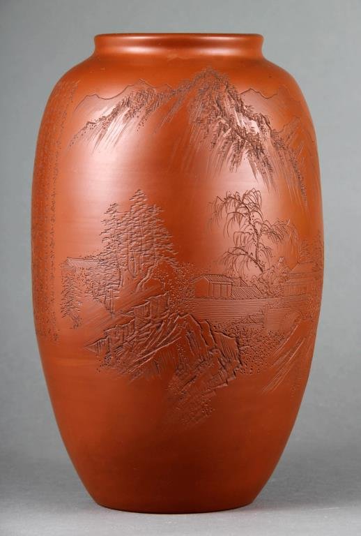 A Fine Japanese Pottery Vase With Inscriptions: The buff colored pottery finely incised to depict a landscape, houses, and mountains, the reverse with multiple lines of inscribed text, appears to be signed in several locations to the left of the te