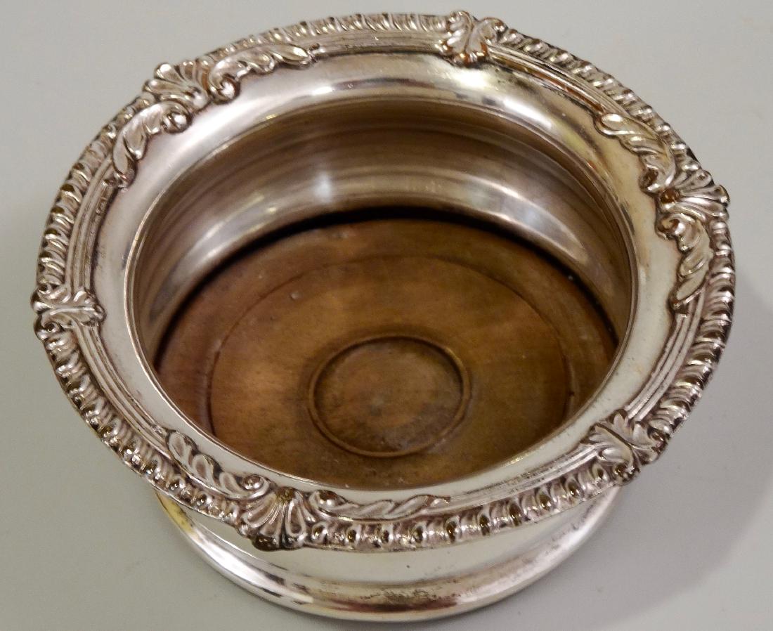 Victorian Wine Bottle Coaster Silver on Copper Turned: Victorian Wine Bottle Coaster Silver on Copper Turned Wood Base Approximately 1 3/4 x 4 5/8 inches in diameter; inner diameter approximately 3 inches.