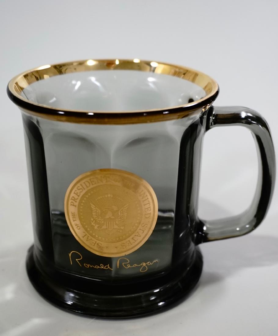 Ronald Reagan Political Memorabilia Gold Seal Signature: Ronald Reagan Political Memorabilia Gold Seal Signature Mug Smoked Topaz Glass Tankard Approximately 5 x 3 3/4 x 3 7/8 inches tall.