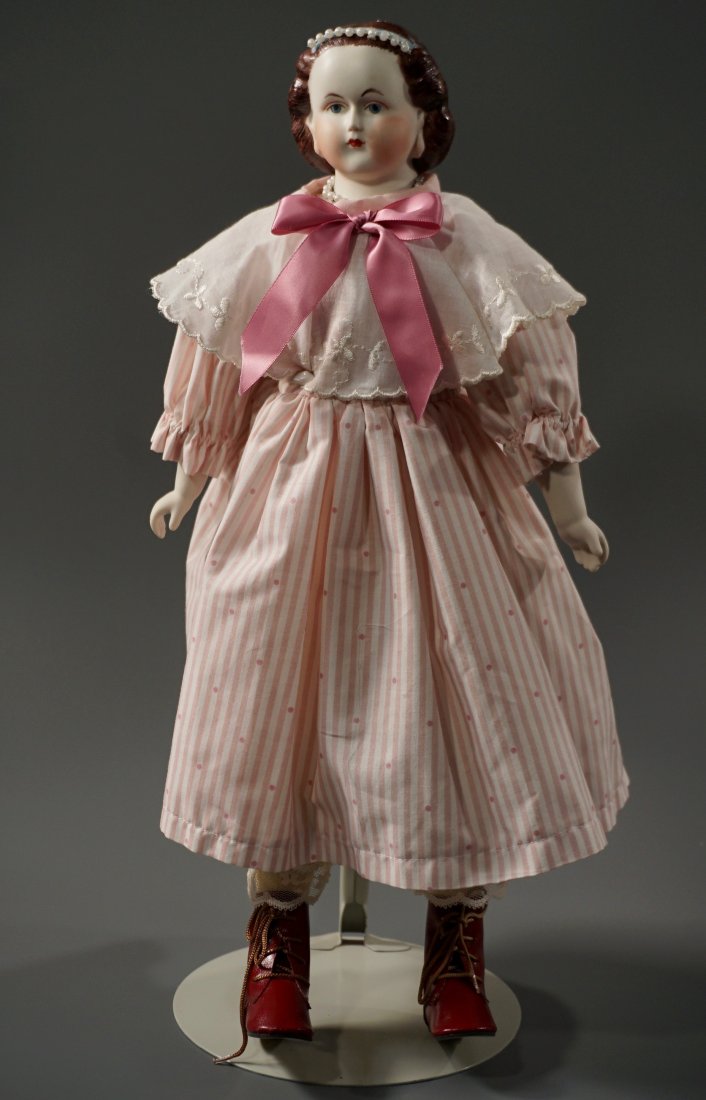 Porcelain Head Pink Dress Cabinet Doll on Display Stand: Porcelain Head Pink Dress Cabinet Doll on Display Stand Approximately 18 inches tall Please check back for updates, we are adding new items daily.