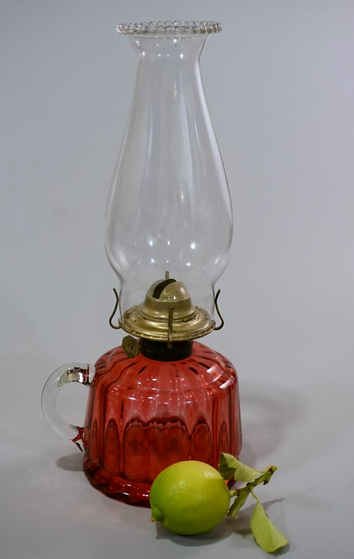Antique Cranberry Glass Kerosene Finger Lamp: Antique Cranberry Glass Kerosene Finger Lamp Antique c 1900 cranberry glass oil lamp with a clear glass handle and clear glass shade. Approximately 12 _ inches tall overall; about 4 _ inches up to the