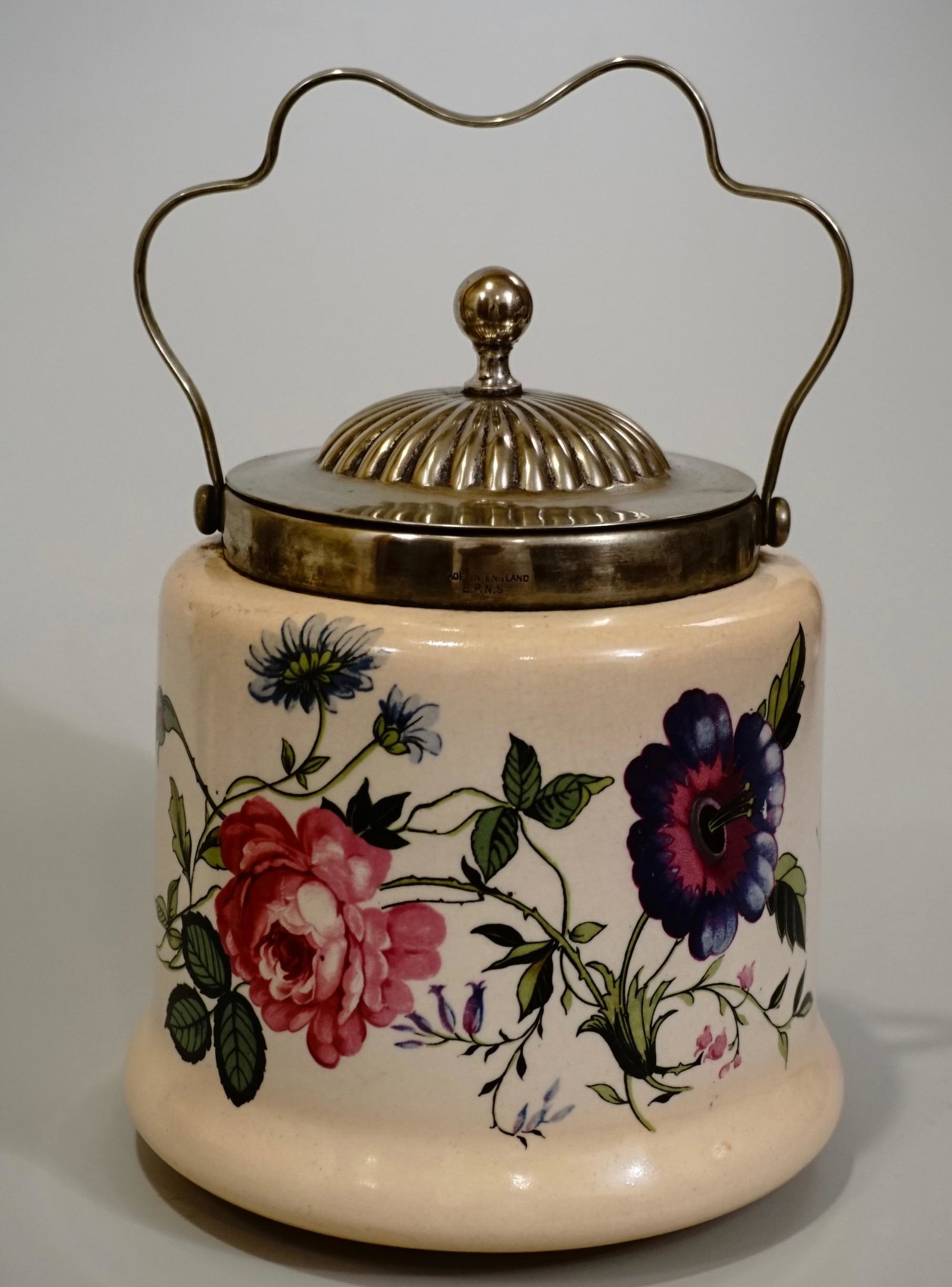 Butterfly Flowers Cookie Jar English Pottery Silver: Butterfly Flowers Cookie Jar English Pottery Silver Plated Lid Approximately 7 5/16 inches tall without the handle; 6 1/8 inches in diameter.