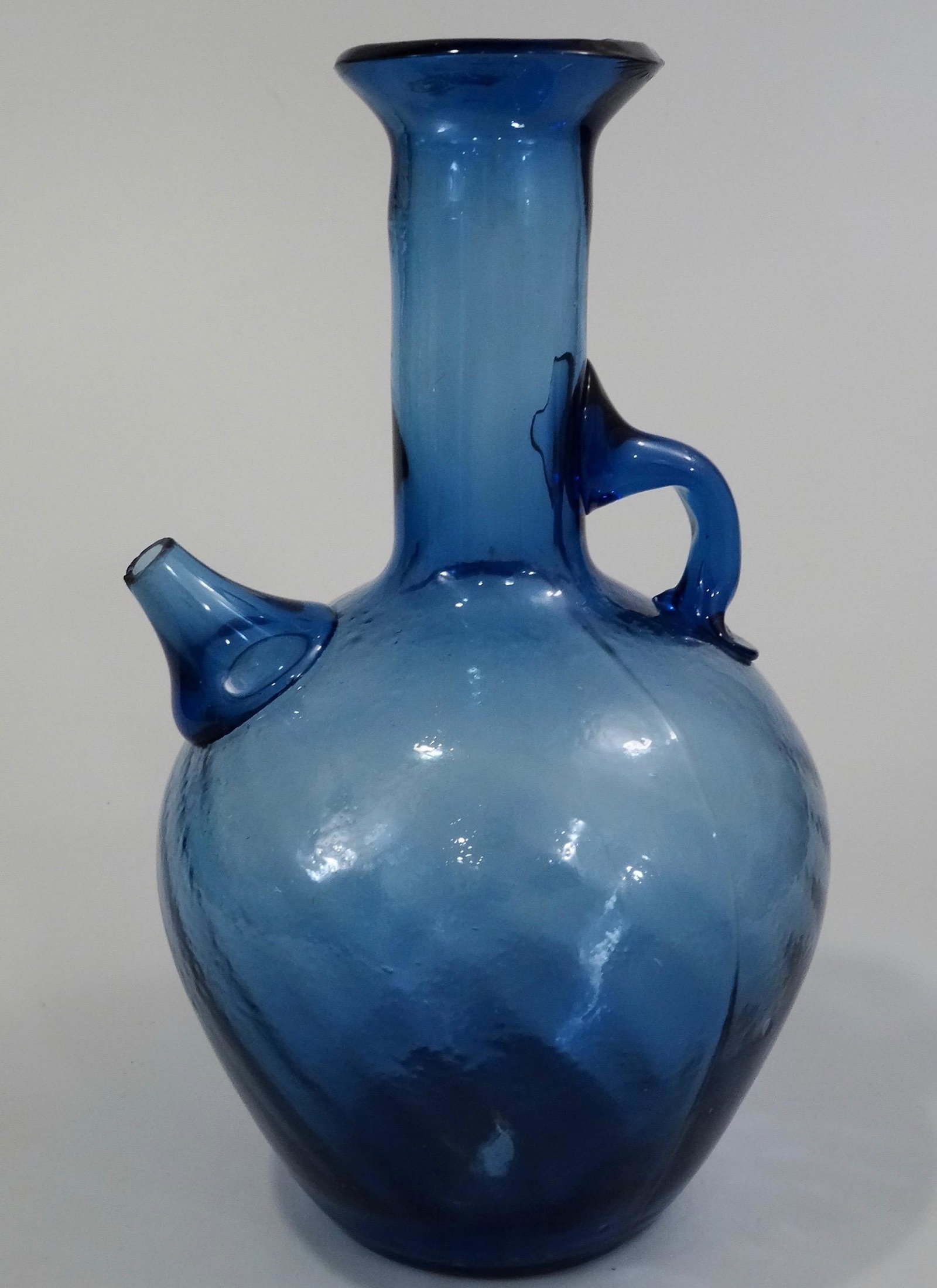 Pontil Blown Blue Art Glass Spouted Bottle Vase: Pontil Blown Blue Art Glass Spouted Bottle Vase Approximately 5 1/8 x 4 5/8 x 8 1/16 inches tall.
