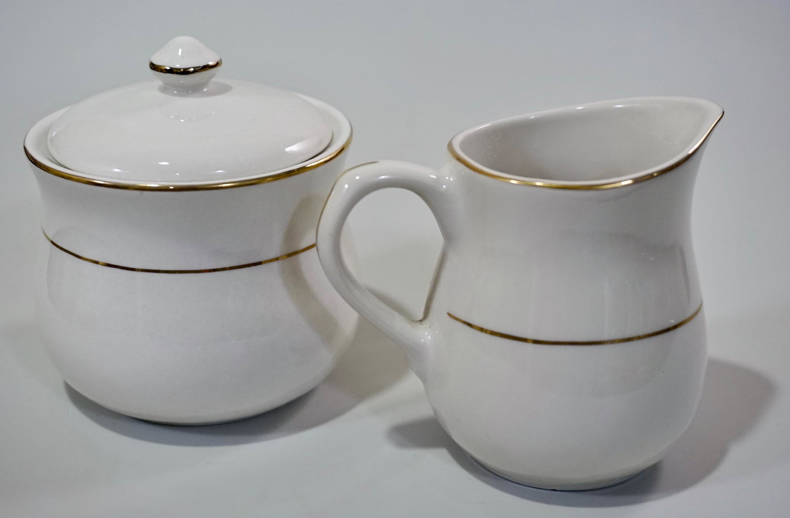 Gibson White Porcelain Cream and Sugar Set: Gibson White Porcelain Cream and Sugar Set Sugar is approximately 4 1/16 x 4 1/8 inches in diameter; creamer is about 4 1/2 x 3 1/4 x 4 inches.