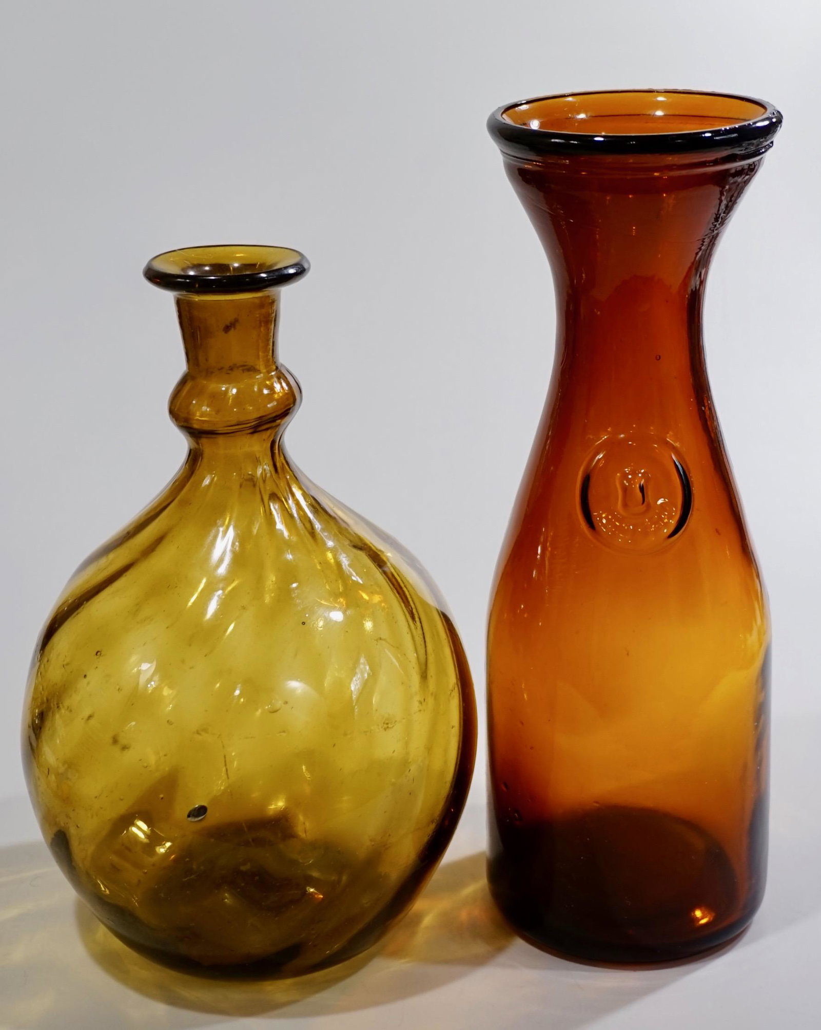 Mid Century Amber Glass Twisted Pontil Blown Bottle: Mid Century Amber Glass Twisted Pontil Blown Bottle Wide Neck Wine Carafe Lot of 2 Items Approximately 8 3/4 and 10 1/2 inches.