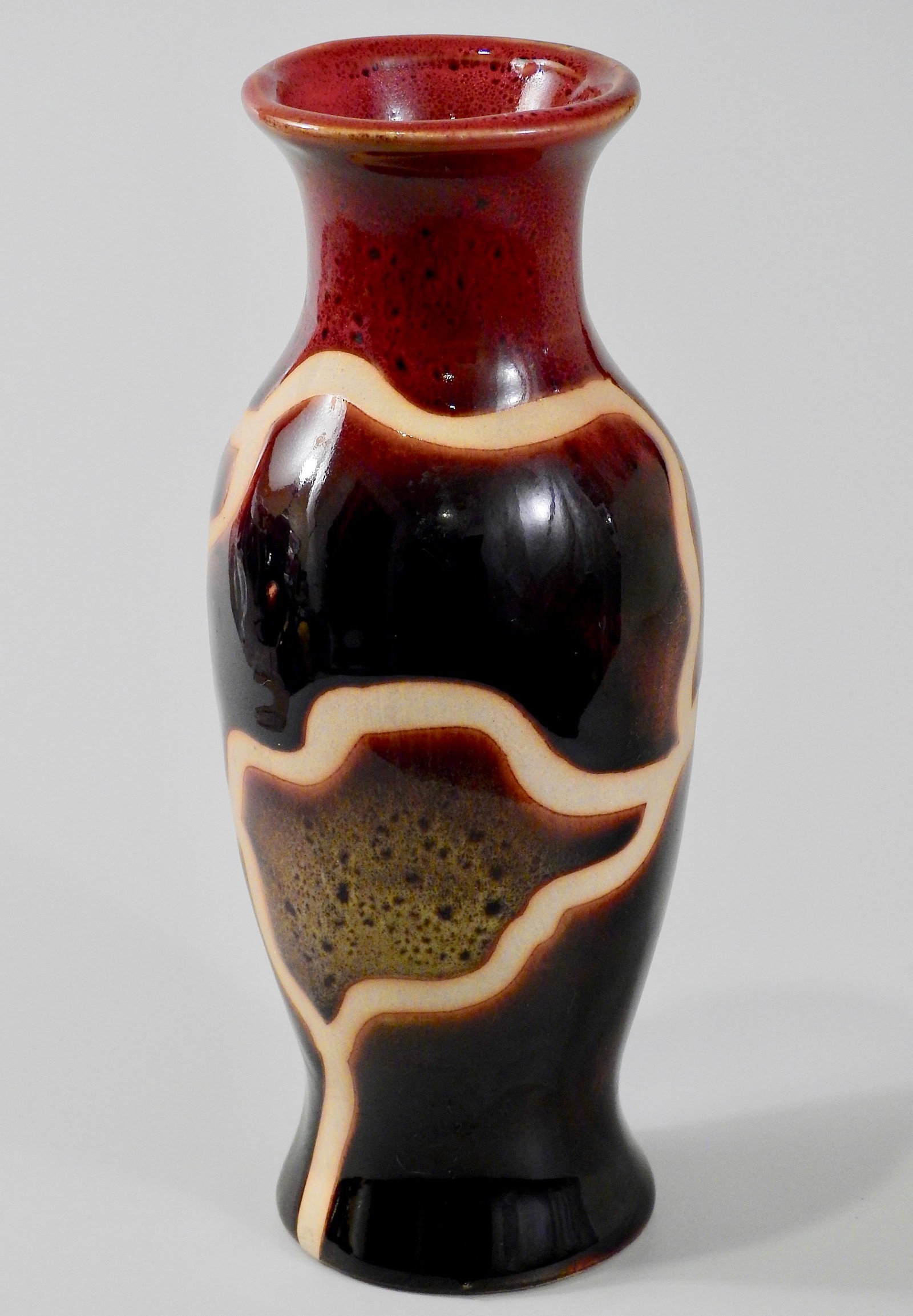 Mid Century Studio Pottery Ox Blood Polychrome Glazed: Mid Century Studio Pottery Ox Blood Polychrome Glazed Vase Approximately 6 3/4 inches tall.