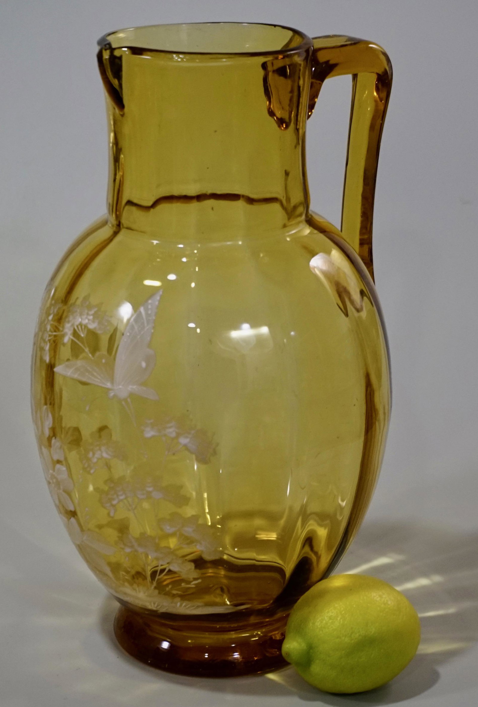 Butterfly Enamel Painted Art Glass Pitcher: Butterfly Enamel Painted Art Glass Pitcher Approximately 6 inches in diameter and 10 7/16 inches tall.