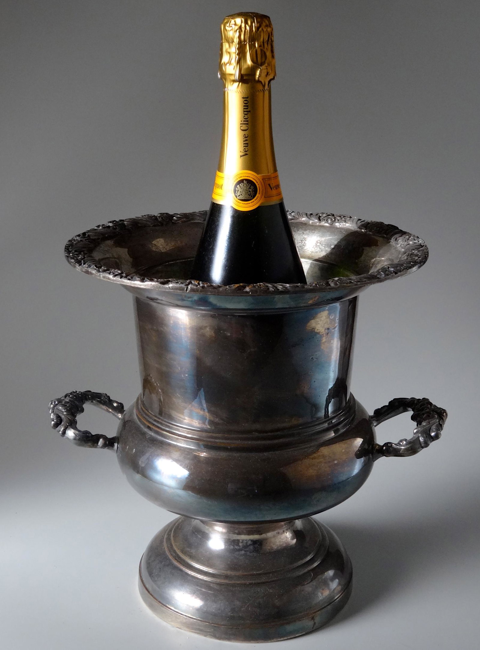 Large King Edward Champagne Urn Bottle Cooler by: Large King Edward Champagne Urn Bottle Cooler by National Silver Company Approximately 10 inches tall; 9 1/4 inches in diameter.