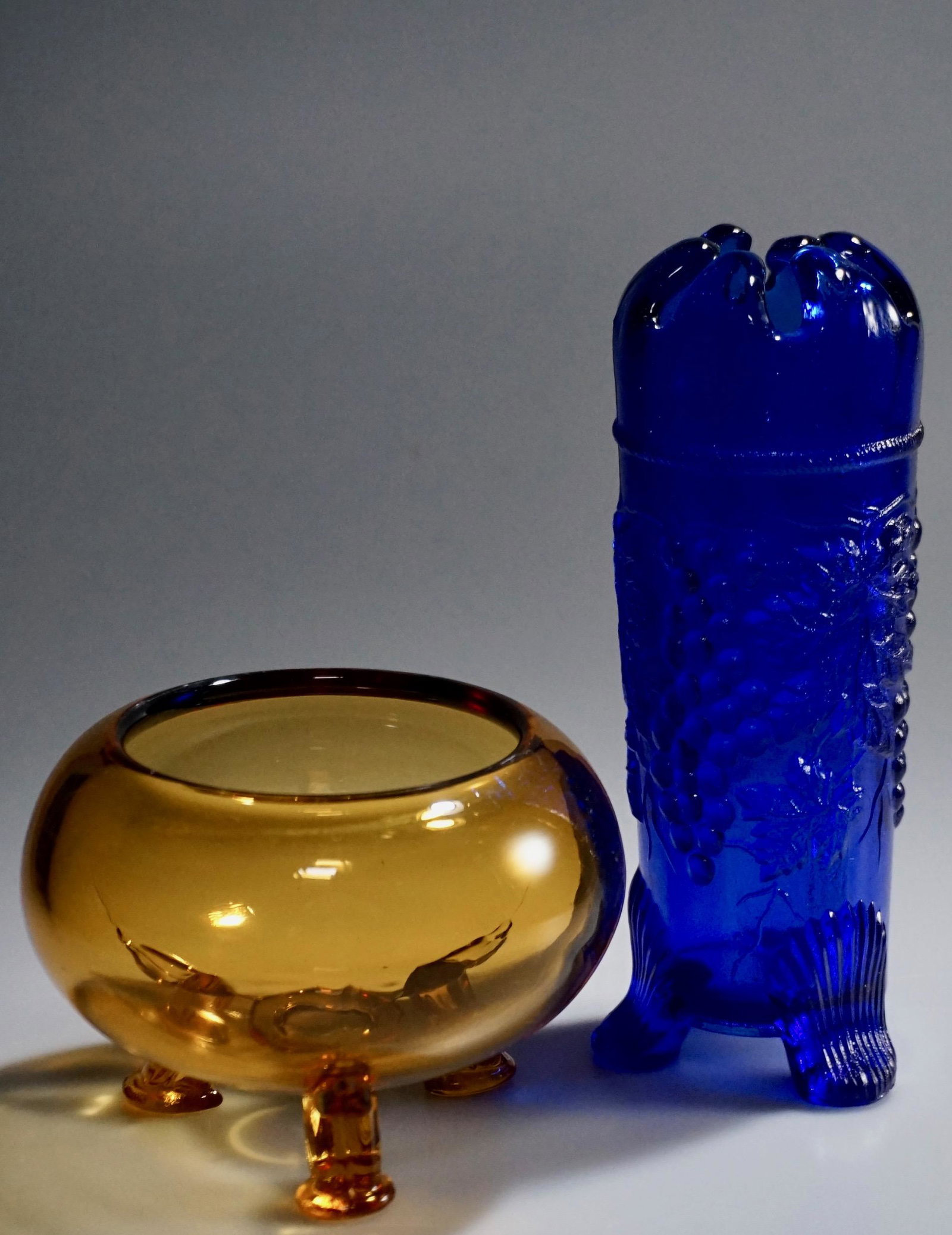 Vintage Colored Glass Footed Bowl Vase Lot of 2 Items: Vintage Colored Glass Footed Bowl Vase Lot of 2 Items Bowl is about 3 3/8 x 4 3/4 inches in diameter; vase is approximately 7 1/8 inches tall.
