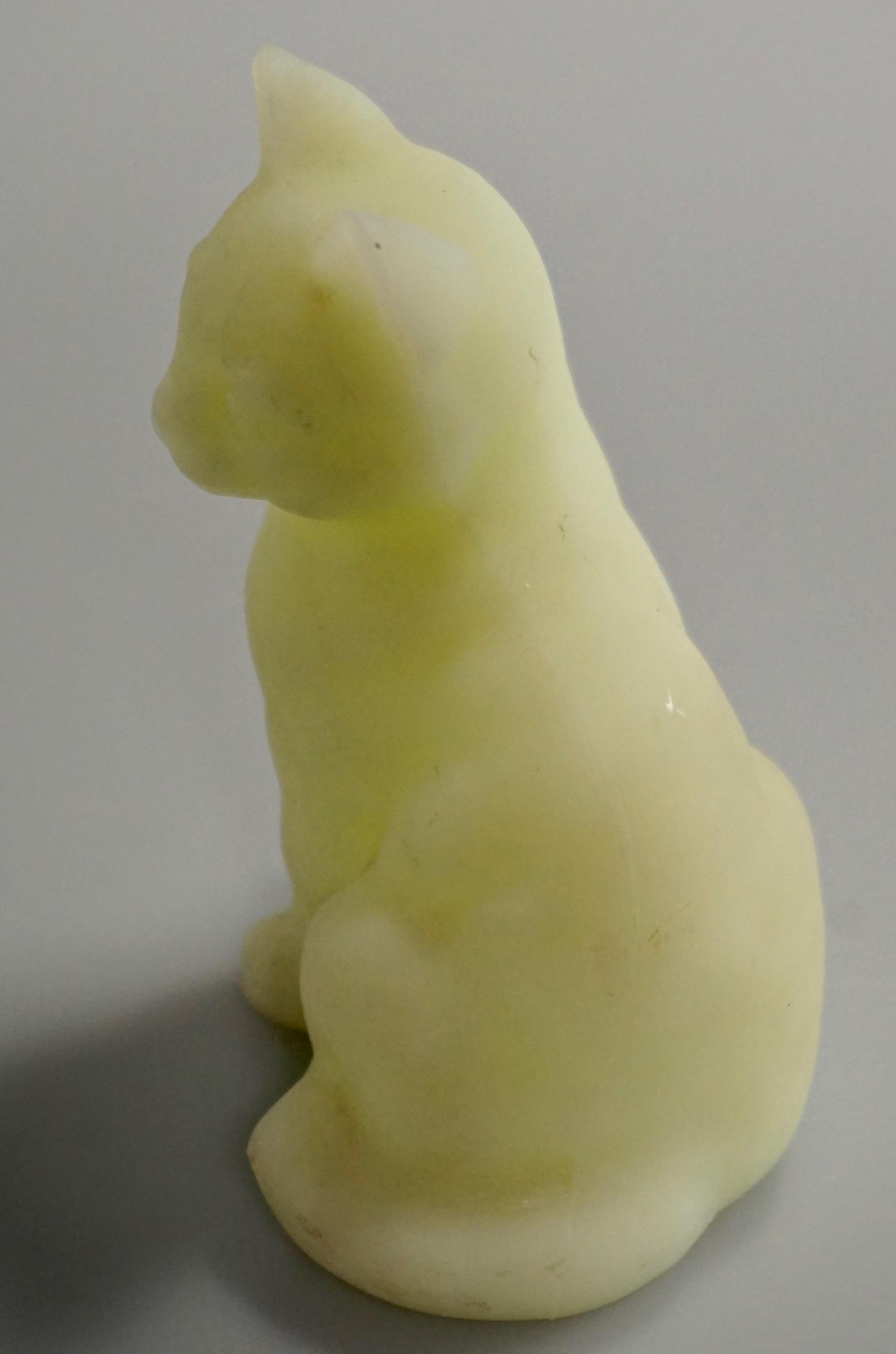 Fenton Custard Green Satin Glass Cat Figurine code: Fenton Custard Green Satin Glass Cat Figurine code number 5165, remains of original label. Approximately 3 11/16 inches tall.