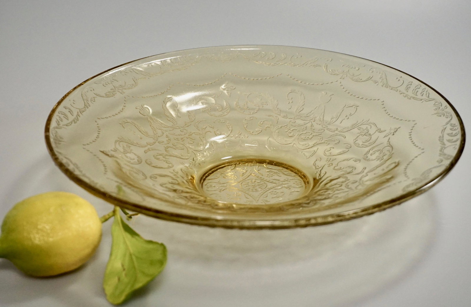 Amber Yellow Pressed Glass Vintage Bowl: Amber Yellow Pressed Glass Vintage Bowl Approximately 11 inches in diameter x 2 1/16 inches tall.